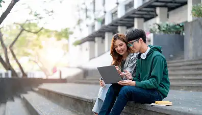 Student using a laptop to complete university registration